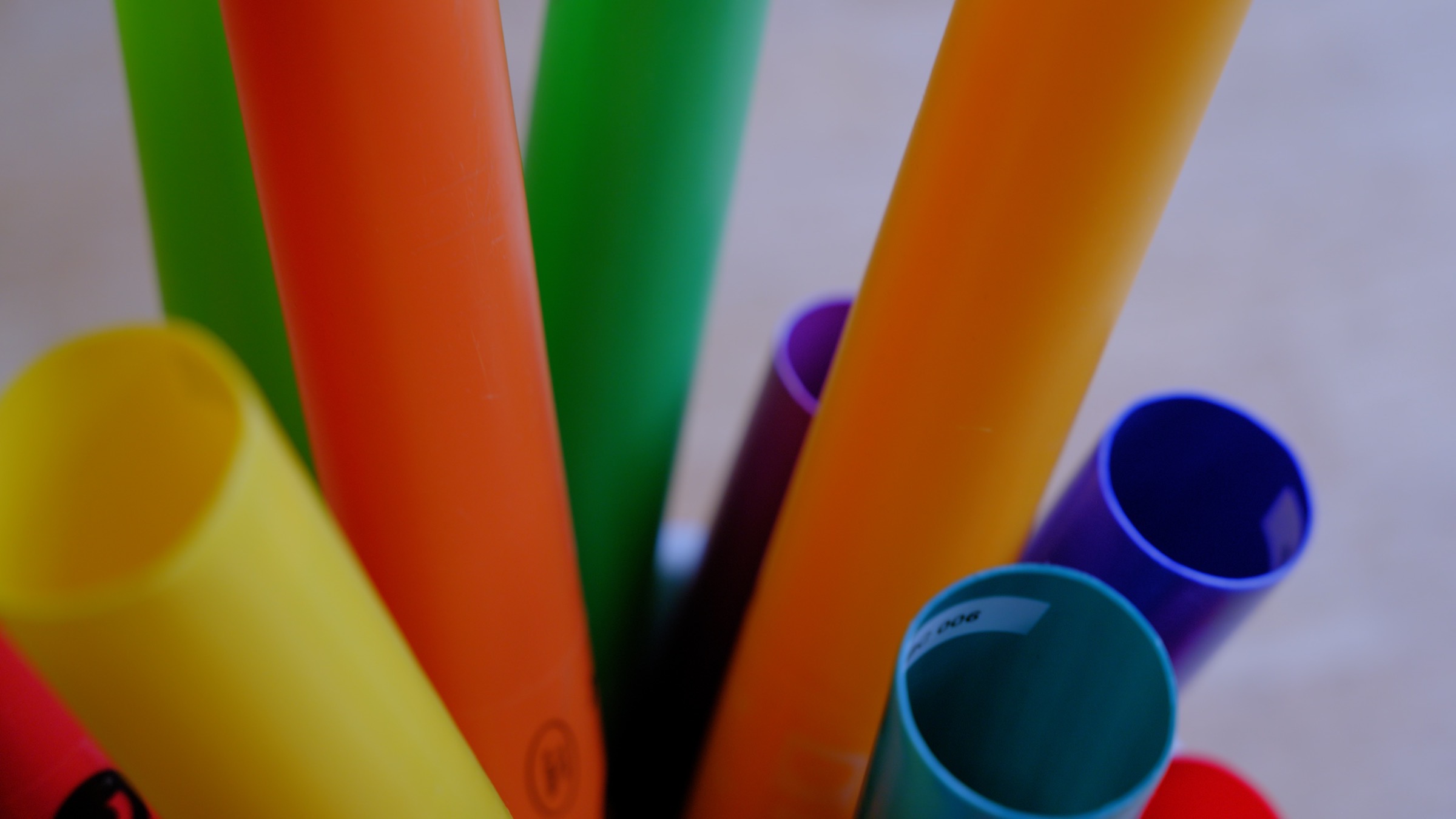 Colourful boomwhackers clustered together, viewed from above